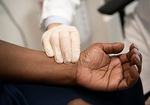 A doctor is examining a patient's wrist.